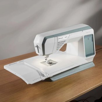 Symaskin av märket Husqvarna Viking och modell Topaz 55Q med ett monterat förlängningsbord som visar den stora arbetsytan och de