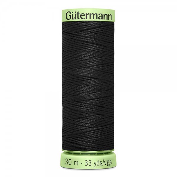 En rulle med svart top stitch tråd