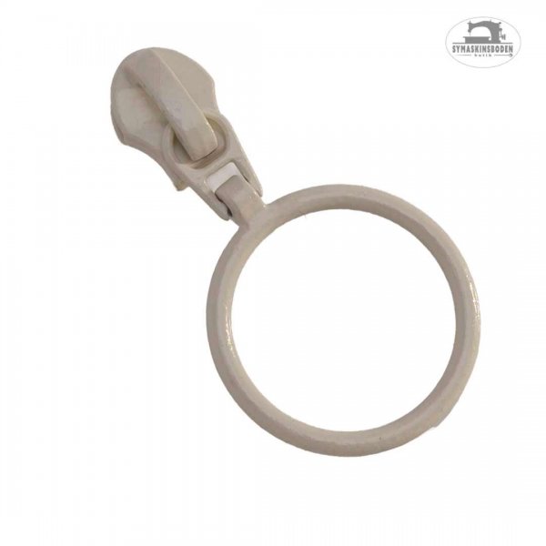 En beige kläpp med ring till spiralblixtlås på metervara.