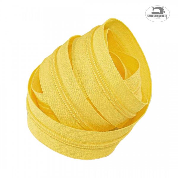 Ett ihoprullat gult blixtlås.