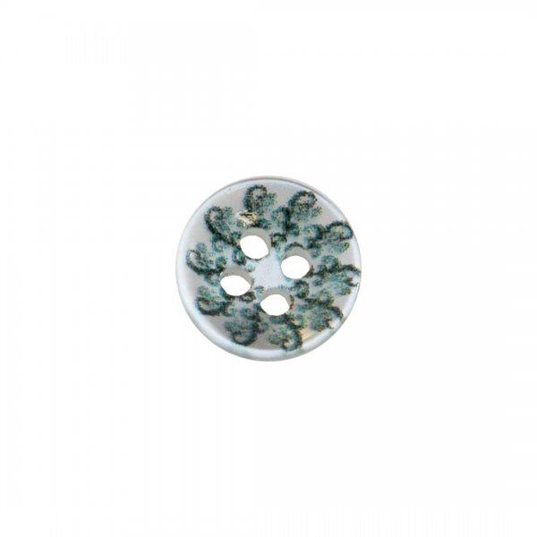 Söt knapp med vit botten och paisleymönster.