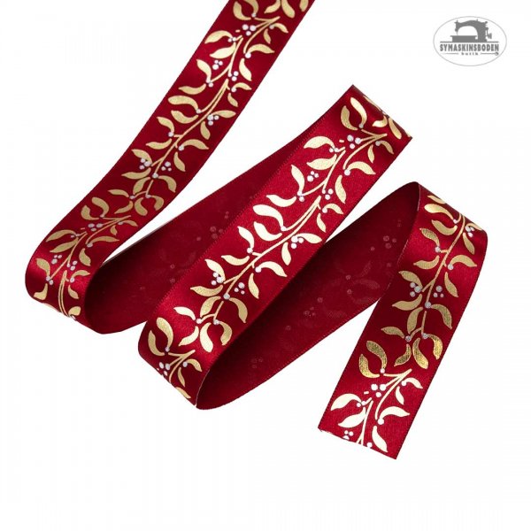 Ett rött satin band med guldigt tryck med mistel.