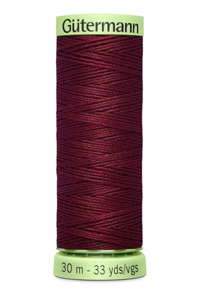 En rulle med vinröd top stitch tråd