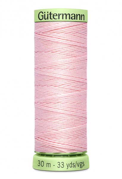En rulle med ljusrosa top stitch tråd