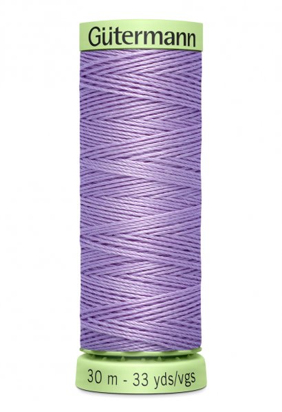 En rulle med lila top stitch tråd