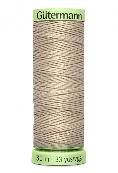 En rulle med beige top stitch tråd