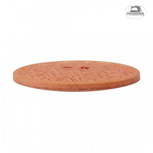 Sidobild av en orange knapp i återvunnet material.