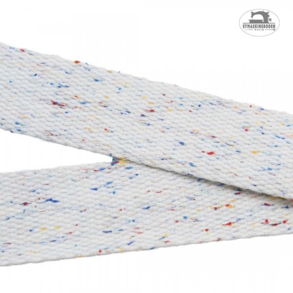 Ett vitt 30 mm brett väskband med små prickar i olika färger som liknar strössel.