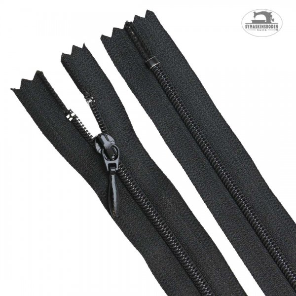 Svart klänningslås som är 25 cm långt.