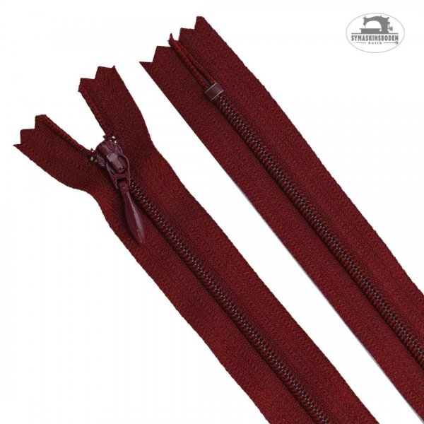 Ett mörkrött blixtlås till klänning och kjol i längd 60cm.