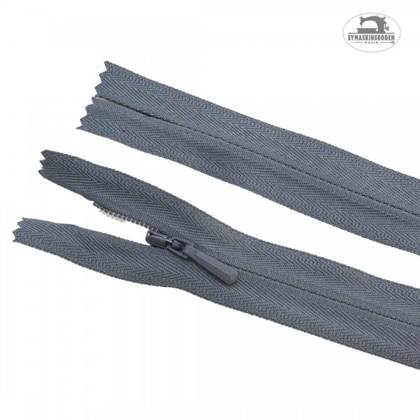 Ett dolt blixtlås med färgen grå och längd 25cm.