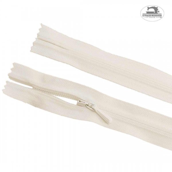 Dolt blixtlås som är 60cm långt och har färgen benvit.